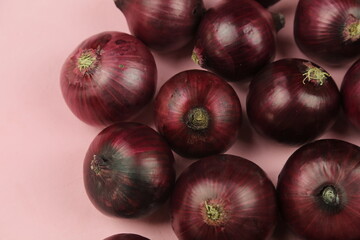 sweet red onions on background