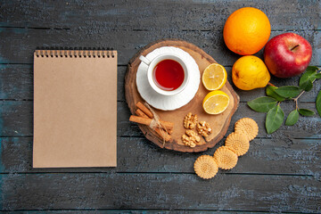 top view cup of tea with fruits and cookies on dark desk ceremony sweet biscuit sugar