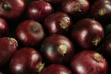 sweet red onions on background