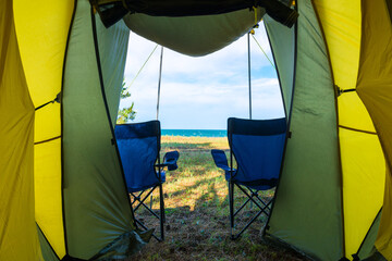 Concept vacation, camping, relaxation - sea view from a camping tent