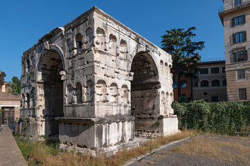 Fototapeta na wymiar Photo of the triumphal arch of Janus, not far from the Temple of Hercules and the Temple of Porturno. Built in the Forum Boarium, near the Velabro, an ancient area of Rome and the Roman Forum.