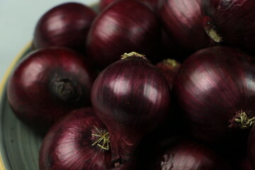 sweet red onions on background