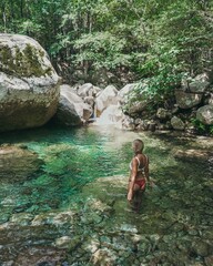 Woman at natural pool in the river in Corsica, France.