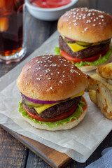 Burgers with meat, tomato, cucumber, cheese and onion. American cuisine. Fast food.