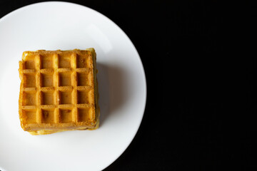 Obraz na płótnie Canvas waffles on a white plate close up