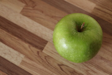 green apple on neutral background.