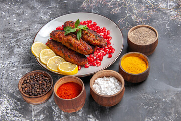 front view long meat cutlets with seasonings on grey background dish meal roll