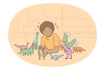 Playing with dinosaurs toys concept. Smiling boy lying on floor at home and playing games with colourful toys reptiles dinosaurs. Education and learning with developing games for children 