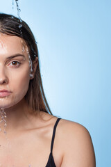 Clean skin, drops and trickles of water on the face. Young beautiful woman,
