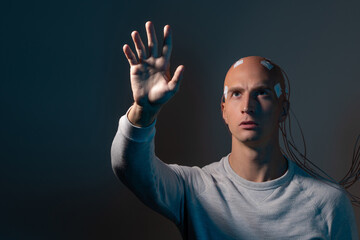 Bald man with electrodes in his brain , futuristic concept,