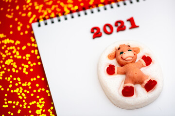 New Year 2021. Christmas greeting backgrounds. Holiday gifts and Christmas sales. The symbol of the year of the bull on a red background with elegant sparkling ornaments and snowflakes.