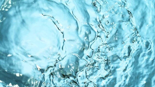 Super Slow Motion Shot of Water Splash at 1000fps on Blue Gradient Background.