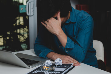 Man lose a job sitting in room, sad young man and sadness emotion concept.