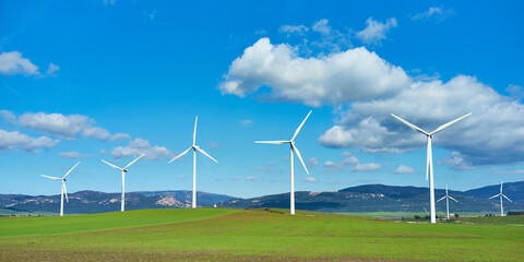 Windmill turbines across picturesque landscape. Energy and ecology concept. Renewable energy
