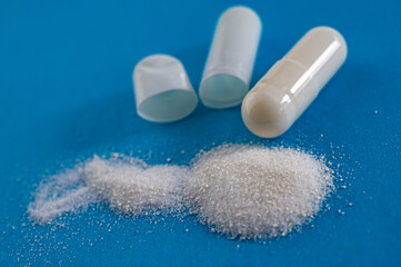 Whole capsule and broken and contained medication mixture.