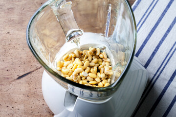 Soybean in blender. Preparing to produce soy milk