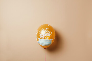 balloon with the text happy new year wearing mask
