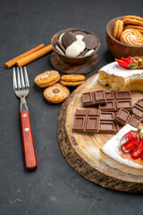 front view cake slices with chocolate and cookies on dark background pie biscuit sweet