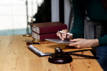 Concepts of Law and Legal services. Lawyer working with digital tablet on table office.