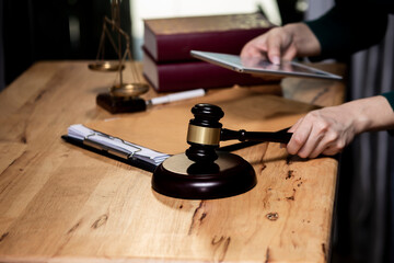Concepts of Law and Legal services. Lawyer working with digital tablet on table office.