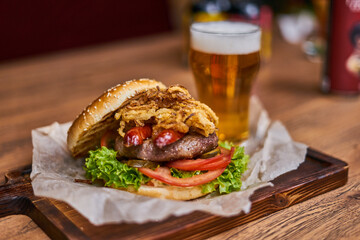  delicious burger with sausages and beer on a wooden board