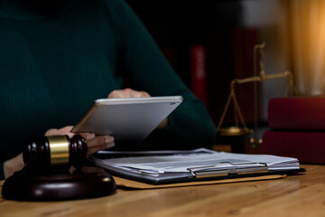 Fototapeta na wymiar Concepts of Law and Legal services. Lawyer working with digital tablet on table office.