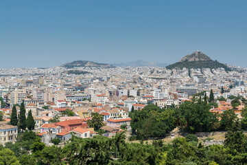 Aerial view of cityscape near Acropolis with crowded buildings of Athens in a sunny day in Greece Areopagus Hill