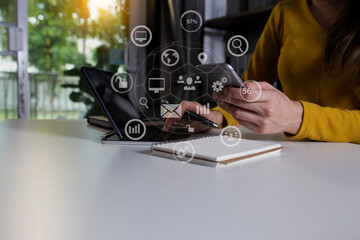 Businesswoman hands using smartphone with network online interface icons. Business digital technology network marketing concept. 