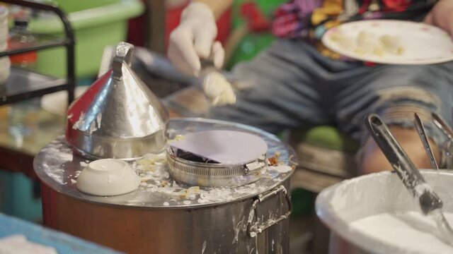 Thai professional street chef cooking traditional food "Pak mor" fluently with fast speed. 