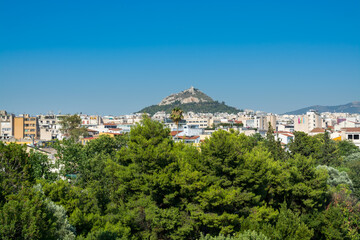 Fototapeta na wymiar Aerial view of cityscape near Acropolis with crowded buildings of Athens in a sunny day in Greece, view from Areopagus Hill