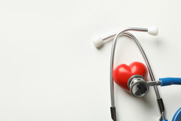 Blue stethoscope and heart on white background