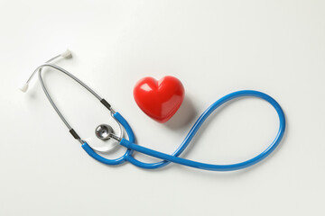 Blue stethoscope and heart on white background