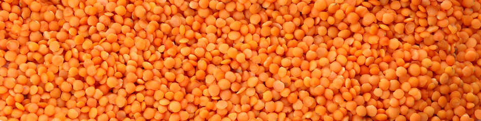 Uncooked red legumes on whole background, top view