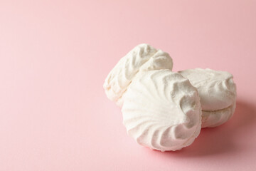 Sweet marshmallow on pink background, space for text