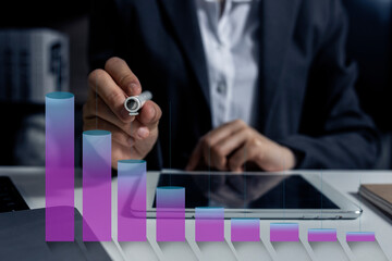 Business hand using tablet and showing a growing virtual hologram of statistics graph chart, Finance business planing and technology strategy concept.