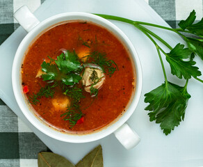 Homemade vegetable soup in a white bowl on a wooden table. Homemade Soup Day