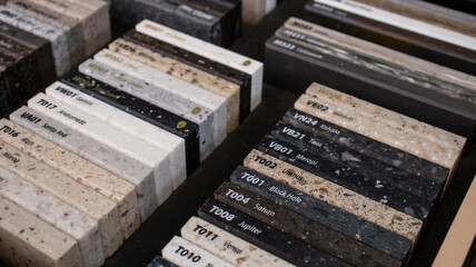 Decorative artificial stone in samples. Suitcase with samples of artificial stone. Finishing material, interior renovation. Gomel / Belarus / 18.12.2020 year