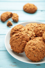 Stack of cookies on the plate on blue background