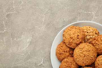 Stack of cookies on the plate on grey background