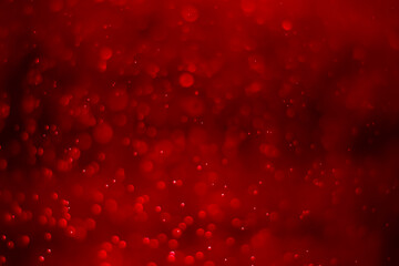 Red glitter vintage lights background. White bokeh on red background.