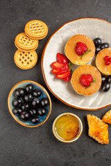 top view yummy pancakes with olives and fruits on dark background fruits sweet cake