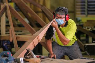 Carpenter making Tunjuk Langit or one of the roof structures. Hip Roof