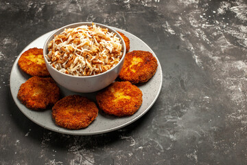 front view fried cutlets with cooked rice on the dark background dish rissole meat