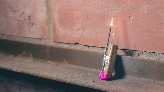 Firecracker Was Lighted Up With a Gas Lighter then Explode Against a Brick Wall. Many Small Particles Flew in a Different Directions - Static Shot