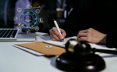 Concepts of Law and Legal services.	Lawyer hand working at table office with interface icon.