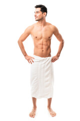 Muscular hispanic wearing towel