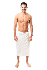 Handsome young man wearing towel