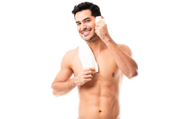 Fototapeta premium Smiling man cleaning face with towel