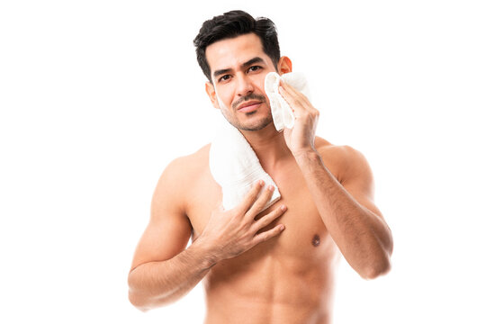 Handsome Young Man Wiping His Face With Towel