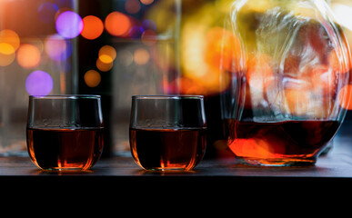 Cheers clinking of friends in party. Whisky In A Glass. Light Bokeh Background.	